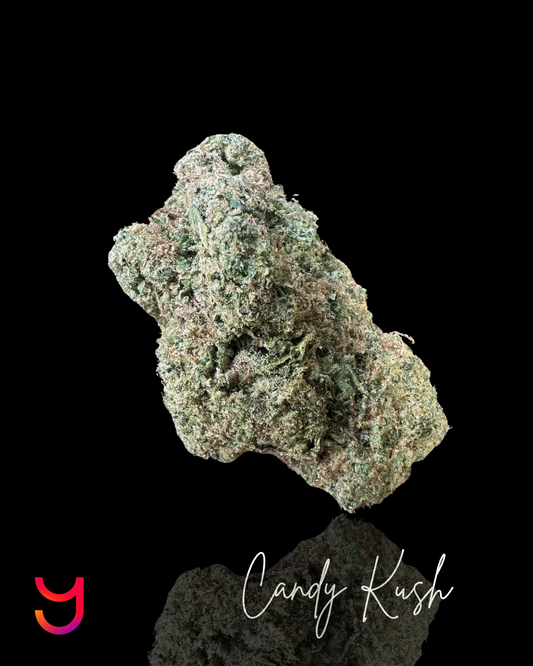 YAGA Farms Candy Kush bud – dense, trichome-rich indica-dominant hybrid with vibrant green hues, amber pistils, and a frosty strawberry-banana aroma.